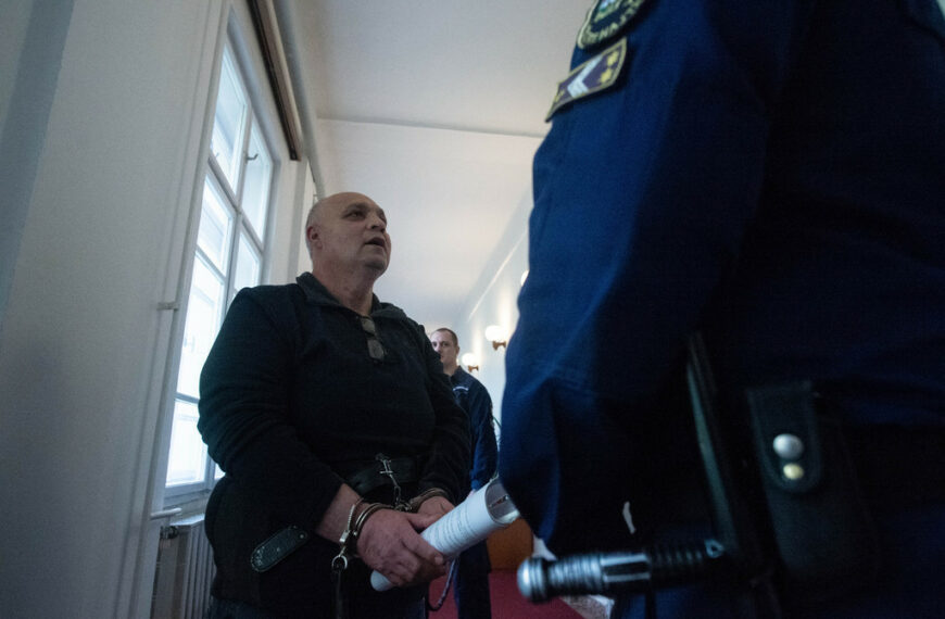 A tárgyalásra kísérik az elsőrendű vádlottat - Fotó: Röhrig Dániel